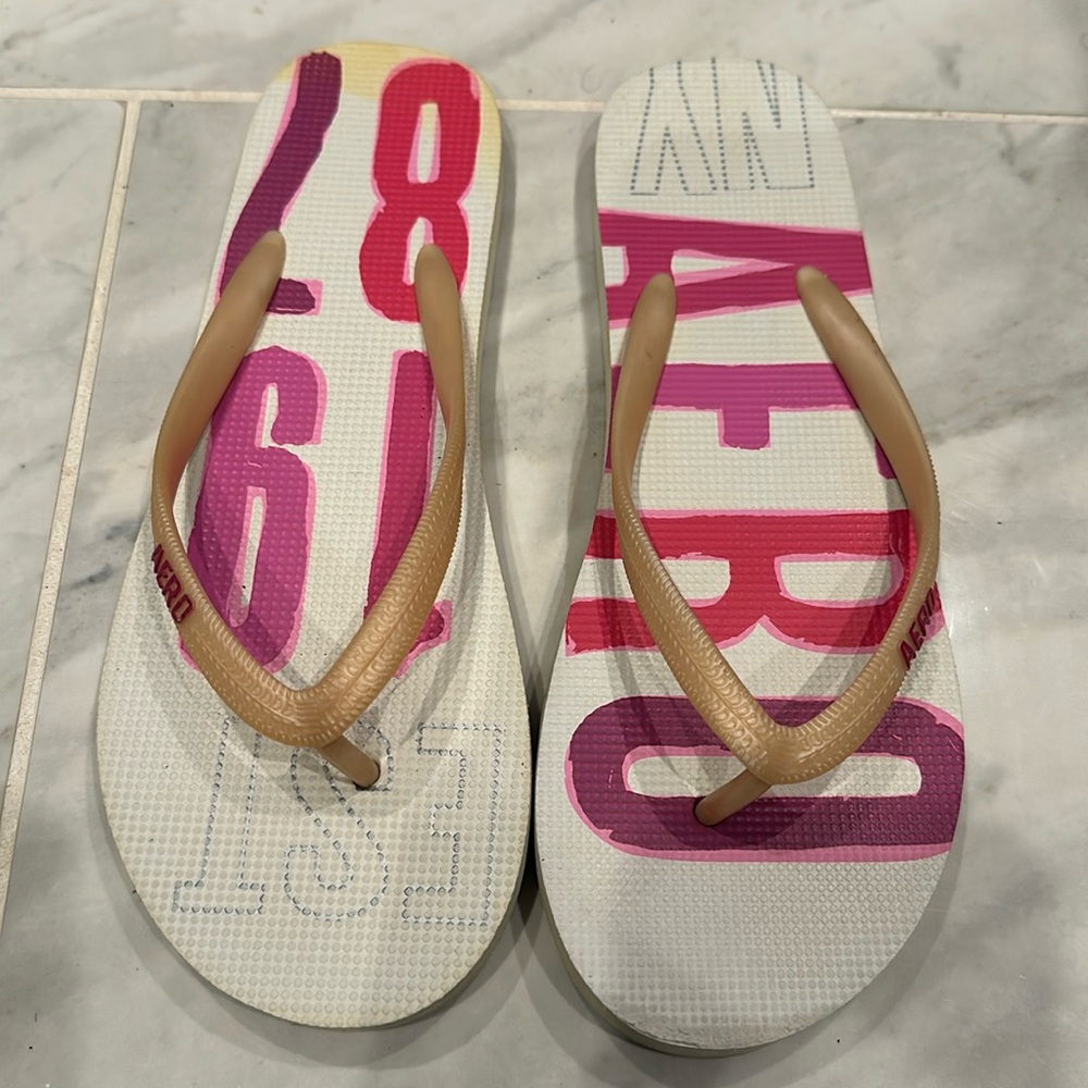 Aeropostale Flip Flops. Women . White Base. Multi color pink/purple. Aero Logo